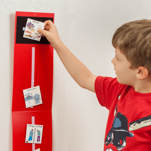 Child using visual schedule board.