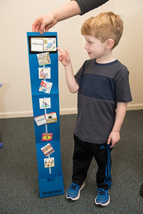 Child choosing activity visual schedule.