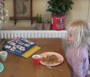 Young girl using PECS during a meal