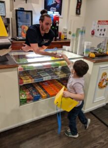 Young child using PECS to buy candy at the movie theater