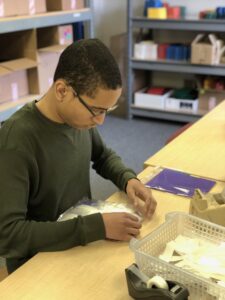 Young man assembling PECS products
