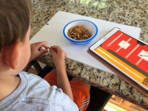 Boy with PECS IV+ app