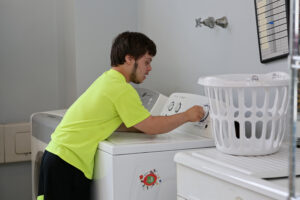 Young adult learner doing laundry